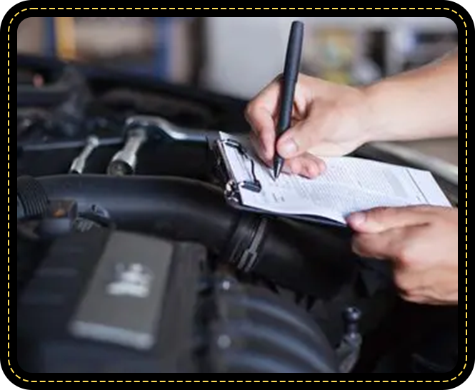 A person writing on paper in front of an engine.