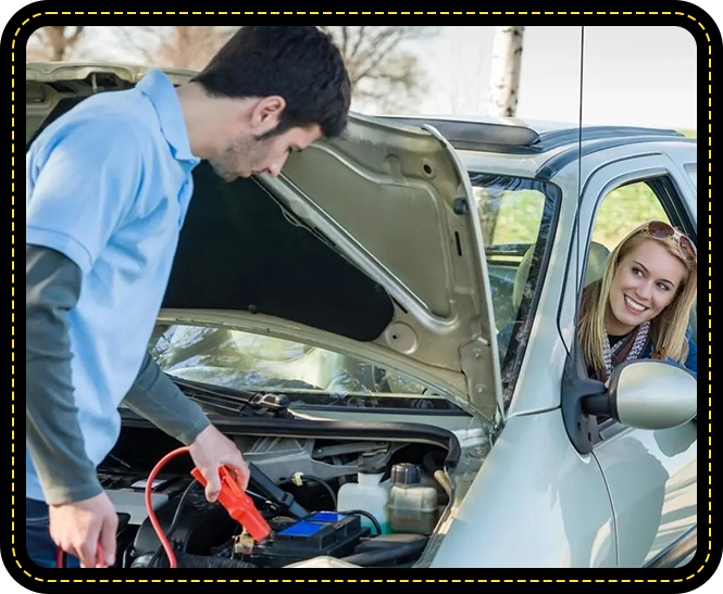 A man is holding an electrical device while another woman looks at him.