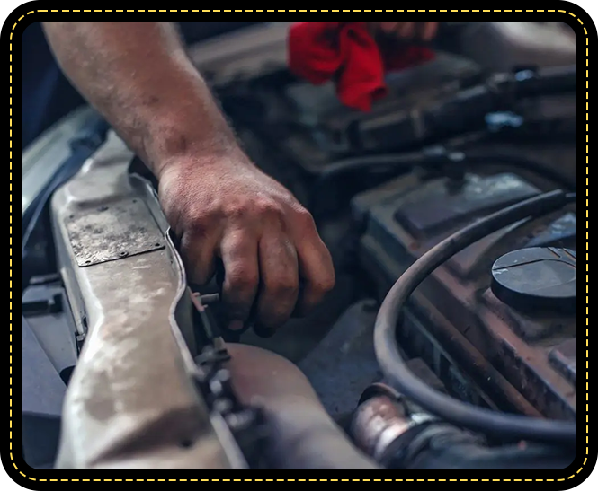 A person working on the engine of an automobile.