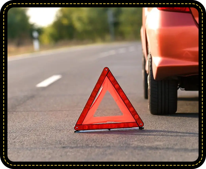 A red triangle sign sitting in the middle of a road.